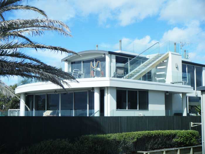 This 450sq/m beauty is made up of concrete, timber and cell-crete, there is 250sq/m of decking surrounded by curved glass.